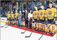  ?? Rob Rasmussen / Quinnipiac Athletics ?? Members of the Quinnipiac men’s hockey team and the Torello family stand together at a ceremony on Oct. 23, 2021, to honor Michael Torello, who had died the previous July. Torello was the Bobcats’ Team IMPACT teammate.