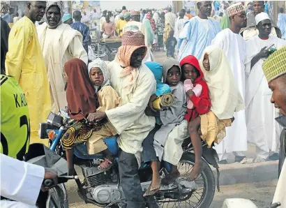  ?? Picture: REUTERS ?? PACKING THEM IN: A man rides a motorbike with his children after prayers to mark the first day of the Muslim holiday of Eid al-Adha in Kano in northern Nigeria. Many people still do not see the link between poverty and having several wives and multiple...