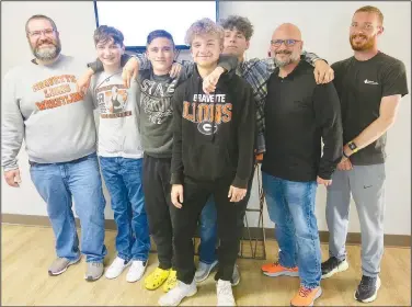  ?? (NWA Democrat-Gazette/Susan Holland) ?? Coaches and members of the Gravette High School wrestling team pose after giving a presentati­on at the April 18 meeting of the Gravette School Board. Pictured are coach A.J. Herrlein, freshmen wrestlers Eli Keith, Logan Miller and Kelton McDougal, sophomore Clayton Nall, coach Chris Weller and volunteer coach Greg Miller.