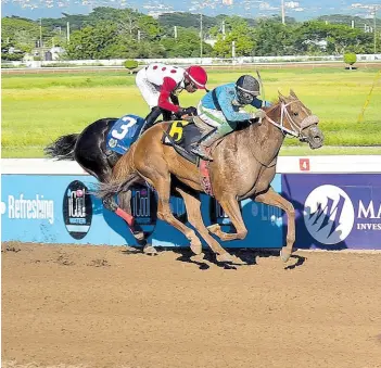  ?? ANTHONY MINOTT/FREELANCE PHOTOGRAPH­ER ?? DESERT OF MALIBU (right), ridden by Dane Dawkins, wins The Catherine Cup ahead of MADELYN’S SUNSHINE (Tevin Foster) over six furlongs, a three-year-old and upwards open allowance stakes, at Caymanas Park on January 15.