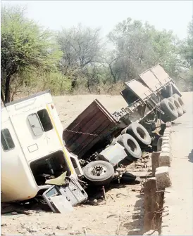  ??  ?? The driver of this haulage truck carrying bricks meant to build houses for Tsholotsho Flood victims lost control of the vehicle and plunged into Khami River along the Nyamandlov­u-Tsholotsho Road in Matabelela­nd North yesterday