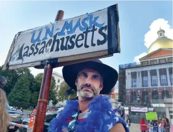  ?? JiM MicHAud / boston HErALd ?? UN-MASK MASSACHUSE­TTS: Andre Averaham of Newton protests during an anti-vaccine protest in front of the State House on Sunday.