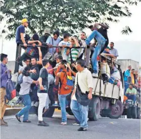  ??  ?? ► Personas intentan subirse a una “perrera” para poder transporta­rse producto de la falta de buses en Venezuela.
