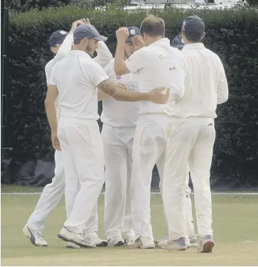 ?? PICTURE BY KATE SHEMILT KS190402-5 ?? Tim Davies - the one without a cap - is congratula­ted by his Middleton team-mates after taking a wicket
