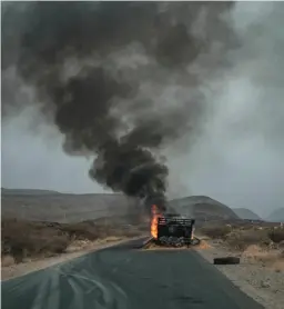  ?? AFP via Getty Images ?? A truck, carrying grains to Tigray and belonging to the World Food Programme, burns 50 miles from Semera, Ethiopia, in June.