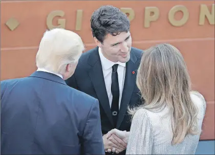  ?? AP PHOTO/ANDREW MEDICHINI ?? U.S. President Donald Trump and First Lady Melania, talk with Canadian Prime Minister Justin Trudeau as they arrive for a concert in the Ancient Theatre of Taormina in the Sicilian citadel of Taormina, Italy, Friday. Leaders of the G7, including...