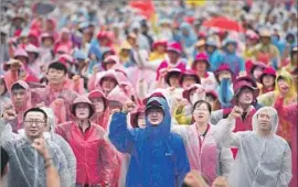  ?? Jung Yeon-je AFP/Getty Images ?? SOUTH KOREANS hold an anti-U.S. rally in Seoul to demand peace on the Korean peninsula. South Korea’s president warned the U.S. against acting alone.