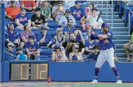  ?? Jeff Roberson/Associated Press ?? The New York Mets’ Tommy Pham stands in the on-deck circle as a pitch clock counts down during the sixth inning of a spring training game against the Washington Nationals on Sunday in Port St. Lucie, Fla.