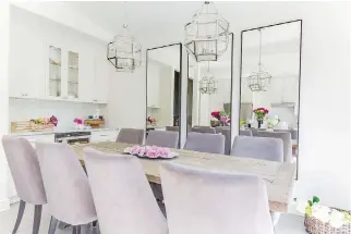  ?? PHOTOS BY GUILLERMO CASTRO, COURTESY OF HIBOU DESIGN ?? Velvet upholstere­d dining room chairs in a soft lilac shade add a stylishly colourful touch to the ultra-modern decor in this Griffintow­n condo.