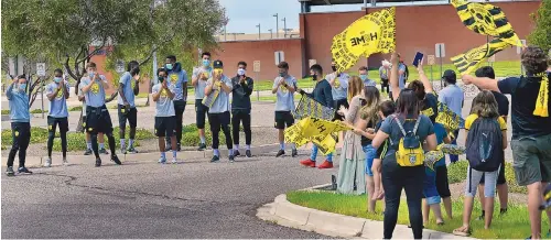  ?? JOURNAL ?? New Mexico United soccer coaches and players thank the fans who came out to give them a send-off for an out-of-state game in August 2020.