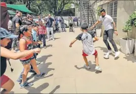 ?? HT PHOTO ?? Virat Kohli plays street football as part of an initiative to encourage children to embrace sports.