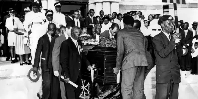  ?? FILE PHOTOS ?? Pall-bearers of the UNIA with the casket of Marcus Garvey leaving the Holy Trinity Cathedral after a solemn Requiem High Mass was celebrated. The procession then moved to the George VI Memorial Park where the body was reburied with further church and state ceremony.