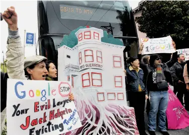  ?? Paul Chinn / The Chronicle ?? Tommi Avicolli Mecca (left) and other protesters, angered by the number of Ellis Act evictions on tenants, prevent a Google worker shuttle from leaving 18th and Dolores streets in San Francisco.