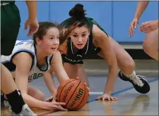  ?? CHRIS CHRISTO — BOSTON HERALD ?? Medfield’s Izzy Kittredge and Billerica’s Audrey Toce, right, hit the floor for the ball. Host Medfield played tough defense in a 50-31 victory.