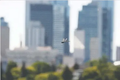  ?? IAN KUCERAK ?? A dragonfly flutters above the field at Forest Heights Park as the temperatur­e soars past 30 C on Monday.