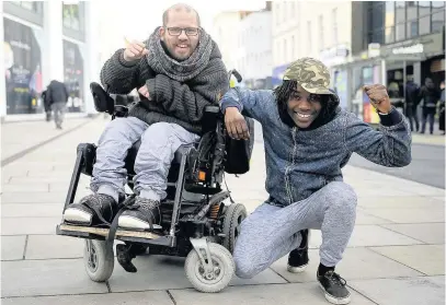  ?? ANDREW HIGGINS ?? Adam Stanton-Wharmby, who has cerebal palsy, will be embarking on a fundraisin­g Cheltenham-to-Cardiff electric wheelchair journey, with carer Leroy Mabonga