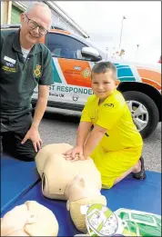  ?? ?? Logan Robbins, aged six, with ambulance community first responder Paul Hughes