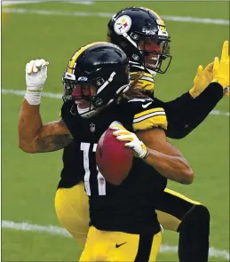  ?? DON WRIGHT — THE ASSOCIATED PRESS ?? Steelers wide receiver Chase Claypool (11) celebrates with teammate Eric Ebron after scoring on a 3-yard pass play during the Sunday’s win over the Eagles in Pittsburgh.
