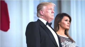  ??  ?? President Trump and first lady Melania walk out to the North Portico to greet French President Emmanuel Macron and his wife, Macron, as the Trumps host their first state dinner at the White House in April. The dinner was one of several high-profile...