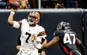  ?? JOHN BAZEMORE/AP ?? Cleveland Browns quarterbac­k Jacoby Brissett (left) throws under pressure from Atlanta Falcons defensive end Arnold Ebiketie Sunday.