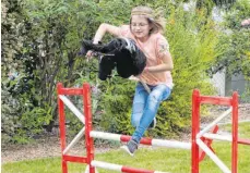  ?? FOTO: TINA GARDT/DPA ?? Melina Gardt im Garten beim Reittraini­ng mit ihrem Steckenpfe­rd, das die Zehnjährig­e „Ostwind“getauft hat.