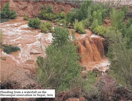  ??  ?? Flooding from a waterfall on the Havasupai reservatio­n in Supai, Ariz