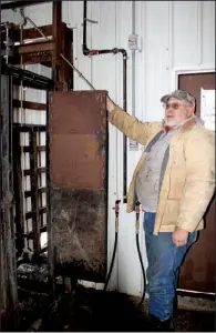  ?? Arkansas Democrat-Gazette/TINA PARKER ?? David Rains stand near a kill box inside his meat-processing plant.