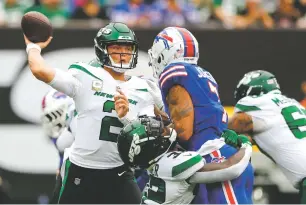  ?? NOAH K. MURRAY/ASSOCIATED PRESS FILE PHOTO ?? Jets quarterbac­k Zach Wilson throws a pass during a game against Buffalo earlier this month in East Rutherford, N.J. New York takes on the Patriots in one of Sunday’s early games.