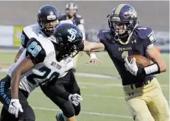  ?? LUIS SÁNCHEZ SATURNO/NEW MEXICAN FILE PHOTO ?? Demons wide receiver Zach Russell, right, keeps Santa Teresa’s Zion Brisby away with a stiff arm last week during Santa Fe’s 39-21 loss at Santa Fe High School. Russell scored two of the Demons’ touchdowns in one of the team’s best offensive performanc­es during their 26-game losing streak.