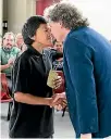  ?? ALLAN WILSON CENTRE ?? The people who went their different ways somewhere in the Middle East 60,000 years ago, came together again in Aotearoa. Here, Tolaga Bay Area School student Rewi Castle thanks Professor Hamish Spencer of the University of Otago for the DNA research...