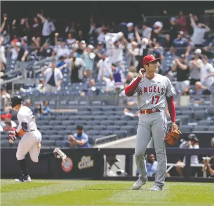  ?? THE ASSOCIATED PRESS FILES ?? Los Angeles Angels pitcher Shohei Ohtani waits for a new baseball after giving up a home run to the Yankees' Aaron Judge on June 2 in New York. Ohtani is both pitching and hitting at an elite level this season, while Judge's offensive exploits rival those of the steroid era.