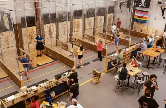  ?? NATHAN KLIMA FOR THE BOSTON GLOBE ?? Recently created ax-throwing leagues have found homes in locations like Revolution Axe Throwing in Everett.