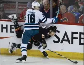  ?? ?? Sharks forward Steven Lorentz, left, checks Flames defenseman Dennis Gilbert during the first period.