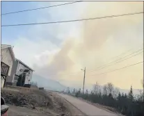  ?? SUBMITTED PHOTO ?? Smoke bellowed from the fire at the Ming’s Bight landfill across the town Monday. The fire led to the evacuation of about 20 families before it was eventually extinguish­ed.