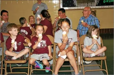  ?? MARTHA GEHRINGER — FOR DIGITAL FIRST MEDIA ?? Students enjoy ice cream cones during the Dairy Day celebratio­n at St. Francis Academy in Bally.