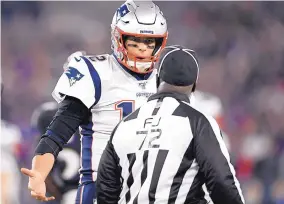  ?? AP FILE ?? New England quarterbac­k Tom Brady, left, talks with field judge Michael Banks during the Patriots’ loss to the Baltimore Ravens Sunday night.