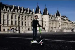  ?? (AFP/Getty) ?? Director general for France of Lime scooters, Arthur-Louis Jacquier, rides on the company’s launch day in Paris in 2018