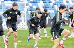  ?? AP PHOTO ?? South Korea’s Son Heung-min, center, warms up during South Korea’s official training on the eve of the group F match between Sweden and South Korea at the 2018 soccer World Cup in the Nizhny Novgorod stadium in Nizhny Novgorod, Russia, Sunday.