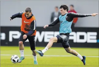  ?? David Vincent ?? The Associated Press French teammates Antoine Griezmann, left, and Benjamin Pavard at a training session at the World Cup in Glebovets, Russia. France and Spain are listed at 13-2 to win the event.