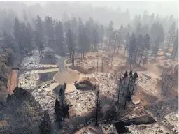  ?? CAROLYN COLE/LOS ANGELES TIMES ?? An aerial view of Paradise, California, on Thursday. The Camp Fire has burned almost 10,000 structures in Paradise, with at least 70 people killed.