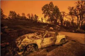  ?? NOAH BERGER — THE ASSOCIATED PRESS ?? Cars scorched by the Carr Fire rest at a residence in Redding on Friday. The fire rapidly expanded Thursday when erratic flames swept through the historic Gold Rush town of Shasta and nearby Keswick, then cast the Sacramento River in an orange glow as they jumped the banks into Redding.