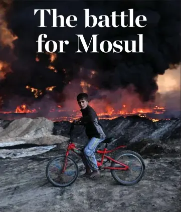  ?? CARL COURT/GETTY IMAGES ?? A boy pauses on his bicycle as he passes an oilfield set ablaze by retreating Daesh fighters in Qayyarah, Iraq.