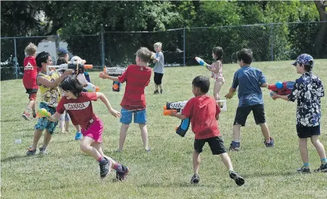  ?? ED KAISER/EDMONTON JOURNAL ?? Belgravia School students and staff hold their annual end-of-the-school-year water fight in the playground on Friday.