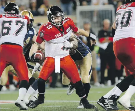  ?? JOHN WOODS/ THE CANADIAN PRESS ?? Calgary Stampeders quarterbac­k Bo Levi Mitchell tries to break free of Winnipeg Blue Bombers defender Jamaal Westerman during the first half of their game at Investors Group Field in Winnipeg Friday night. The Stampeders held on for a 25-23 victory.