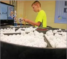  ?? KEVIN TUSTIN — DIGITAL FIRST MEDIA ?? AN entire tray of spherical Zometools wait to be used as 11-year-old Aidan O’Connell works on the satellite he’s making.