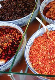  ??  ?? Various Sichuan-style hot sauces, including pickled chili peppers and red oil, are usually offered at hot pot restaurant­s and buffets