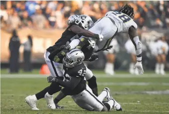  ?? Thearon W. Henderson / Getty Images ?? Safety Karl Joseph (42) gets in on the tackle as the Raiders bring down the Chargers’ Melvin Gordon on Nov. 11. Joseph was a starter last season, but things changed early in this season.