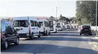  ??  ?? Minibuses queueing to get in the school