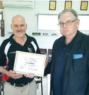  ??  ?? Peter Flahavin receives his Gippsland cricket life membership from Gippsland Cricket League president George Munro.