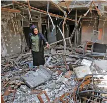  ?? - Reuters ?? HELPING HAND: Raghad Hammoudi, who is a member of a group of students campaignin­g to help rebuild the Central Library of Mosul University, speaks in Mosul, Iraq on May 14, 2018.